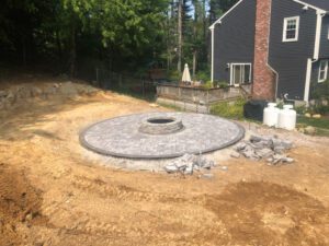 Stone patio outdoor fire pit area outside the house