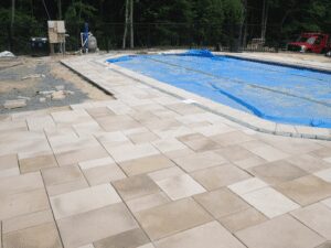 A picture of the sandstone flooring under construction near the pool